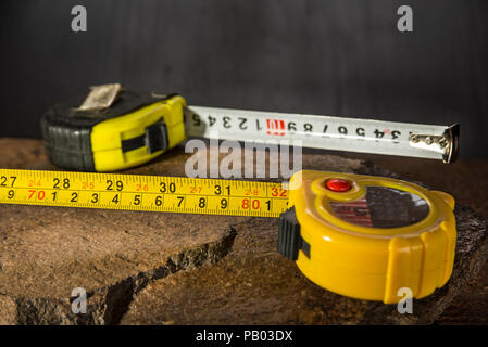 Measure tapes on the stone and dark background Stock Photo