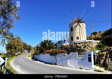 Traditional greek windmill on the road, Naxos island, Greece Stock Photo