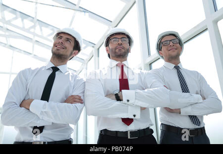 three architects standing in an empty office Stock Photo
