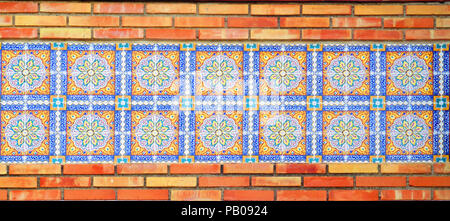 Closeup of decorative Tiles recessed in brick wall in Andalusian village Stock Photo