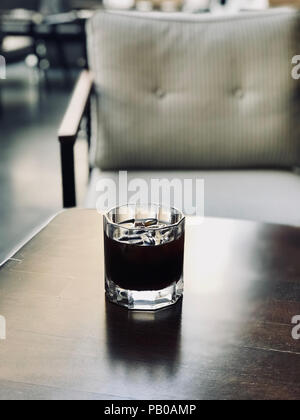 Cold Brew Coffee with ice served at Cafe Shop (without milk). Organic Summer Beverage. Stock Photo