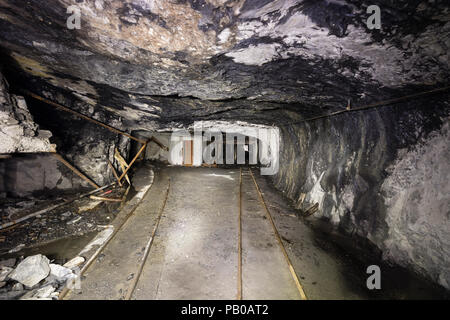 Railway tracks in a tunnel of an abandoned lime mine in Switzerland Stock Photo