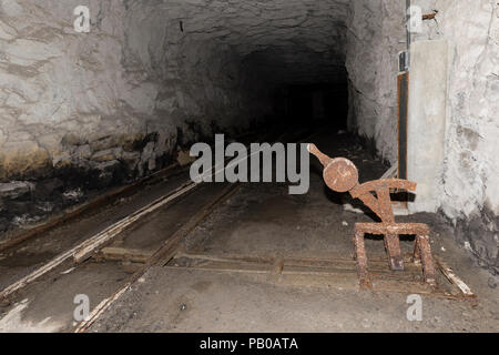 Railway tracks with a crossover in a tunnel of an abandoned lime mine in Switzerland Stock Photo