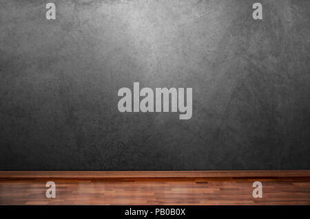 Concrete wall in a room with a wooden brown floor Stock Photo