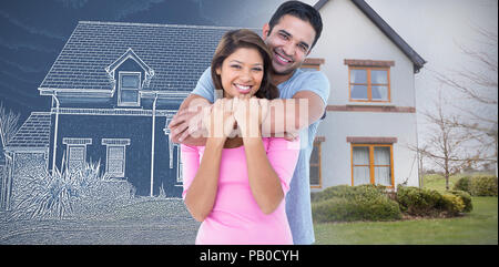 Composite image of happy couple embracing and looking at the camera Stock Photo