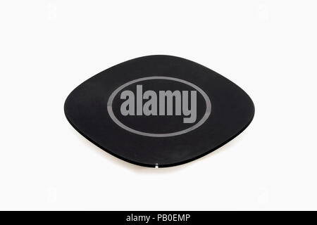 Isolated wireless charger for smartphone on white background. Stock Photo