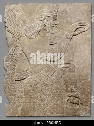 Relief panel. Culture: Assyrian. Dimensions: 64 5/8 x 49 1/2 x 3 1/2 in. (164.1 x 125.7 x 8.9 cm). Date: ca. 883-859 B.C..  This panel from the Northwest Palace at Nimrud (ancient Kalhu) depicts a winged supernatural figure. Such figures appear throughout the palace, sometimes flanking either the figure of the Assyrian king or a stylized 'sacred tree.' The reliefs were painted, but today almost none of the original pigment survives. However, the reliefs themselves retain incredible detail, including intricate incised designs on many of the figures' clothing.  The protective figure on this pane Stock Photo