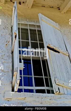 An old wooden shutter covers the exterior window on the St. Marks Lighthouse in St. Marks Florida, USA Stock Photo