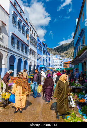 Locals buying vegetables and fruits, market in front of Blue Houses, Chefchaouen, Chaouen, Tangier-Tétouan, Kingdom of Morocco Stock Photo
