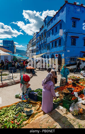 Locals buying vegetables and fruits, market in front of Blue Houses, Chefchaouen, Chaouen, Tangier-Tétouan, Kingdom of Morocco Stock Photo