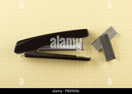 black stapler with paper clips shot close-up Stock Photo