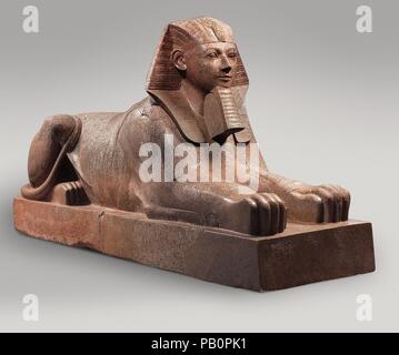 Sphinx of Hatshepsut. Dimensions: H: 164 cm (64 9/16 in.); L: 343 cm (135 1/16 in.); Wt: 6758.6 kg (14900  lb.). Dynasty: Dynasty 18. Reign: Joint reign of Hatshepsut and Thutmose III. Date: ca. 1479-1458 B.C..  This colossal sphinx portrays the female pharaoh Hatshepsut with the body of a lion and a human head wearing a nemes headcloth and royal beard.  The sculptor has carefully observed the powerful muscles of the lion as contrasted to the handsome, idealized face of the pharaoh. It was one of at least six granite sphinxes that stood in Hatshepsut's mortuary temple at Deir el-Bahri.  Smashe Stock Photo