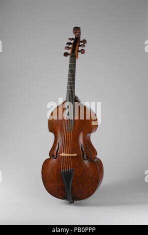 Bass Viola da Gamba. Culture: Austrian. Dimensions: Height: 27 1/16 in. (68.7 cm)  Width (Of lower bout): 15 7/8 in. (40.3 cm)  Depth (At bottom block): 4 3/8 in. (11.1 cm). Former Attribution: Andreas Jais (German, Mittenwald 1685-1753 Tölz). Date: ca. 1669.  Andreas Jais was from a Tyrolean family of instrument builders active in Bolzano in the eighteenth century. Despite its unoriginal narrow neck and fingerboard (replacements from a conversion to the cello), this instrument maintains its original oblong and curvilinear shape, a feature typical of instruments from this region. Museum: Metro Stock Photo