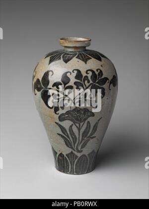 Maebyeong with lotus decoration. Culture: Korea. Dimensions: H. 10 1/2 in. (26.7 cm). Date: 11th century.  The lotus's distinctive open leaf forms the center of the painted design on this maebyeong (plum bottle). Iron pigment typically adds a yellowish tint to celadon glaze, as seen here. The style of the design is similar to those on iron-painted vessels from Cizhou kilns of Song China. Museum: Metropolitan Museum of Art, New York, USA. Stock Photo