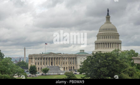 Rainy day view shows U.S. Capitol with Washington Monument, Smithsonian Castle, and Lincoln Memorialin background left. Stock Photo