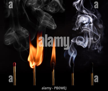 Sequence of ignition of a matchstick from lighting to being blown up and capturing the beautiful drawings made by the smoke. Done on black background Stock Photo
