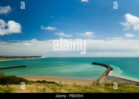 Fishing boat heading out to sea from Newhaven harbour, East Sussex,  England from Fort Hill with the town of Seaford in the distance. Stock Photo