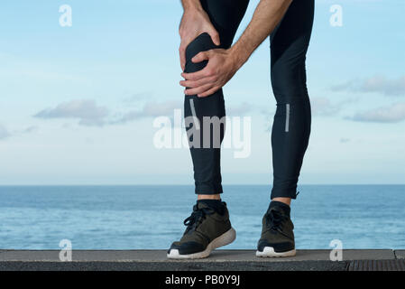 Athlete with knee injury Stock Photo