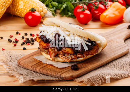 The typical Venezuelan Arepa called Pabellon, which has seasoned minced meat, fried plantain, black beans and white cheese Stock Photo