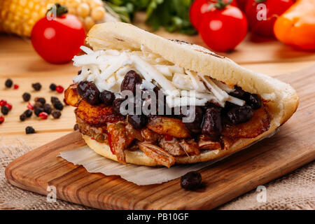 The typical Venezuelan Arepa called Pabellon, which has seasoned minced meat, fried plantain, black beans and white cheese Stock Photo