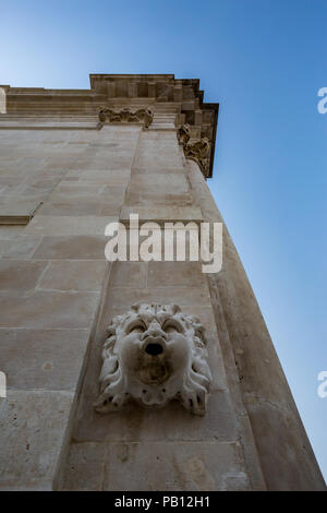 DUBROVNIK, CROATIA - DECEMBER 30, 2014: Beautiful ancient marble gutter downspout in Dubrovnik waits for the rain to start. Low angle winter day photo Stock Photo