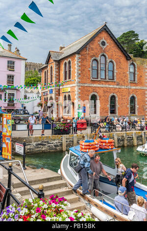 Boat Trips around the picturesque little harbour at Fowey in East Cornwall proving a very popular tourist attraction on a hot summer's day in July. Stock Photo