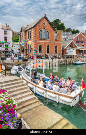 Boat Trips around the picturesque little harbour at Fowey in East Cornwall proving a very popular tourist attraction on a hot summer's day in July. Stock Photo