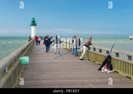 Calais, France - 19 June 2018: Fishermen on the west jetty in the summertime. Stock Photo