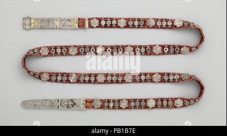 Belt. Culture: North Italian. Dimensions: 65 3/8 × 1 5/16 × 9/16 in. (166 × 3.3 × 1.4 cm)  Other (waist size): 21 1/16 - 33 7/16 in. (53.5 - 85 cm)  Other (width of textile support): 7/8 in. (2.3 cm)  Other (From end of belt buckle to change in orientation): 34 1/16 in. (86.5 cm)  Other (From end of belt strap to change in orientation): 40 3/16 in. (102 cm). Date: ca. 1330-50.  The celebrated Italian poet Giovanni Boccaccio (1313-1375) tells of a silver belt stolen from a virtuous Genoese woman that was offered for sale in the market at Acre, a principal arrival point for European Christian pi Stock Photo