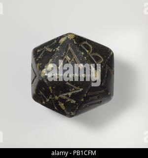 Greenstone polyhedron inscribed with letters of the Greek alphabet. Culture: Greek. Dimensions: Width (point to point greatest width): 3 3/8 in., 22.9oz. (8.6 cm, 647.9g)  Width (point to point smallest): 3 5/16 in. (8.4 cm)  Width (Side to side): 2 13/16 in. (7.2 cm). Date: 2nd-1st century B.C..  The polyhedron has 20 sides, each inscribed with a letter of the Greek alphabet from A (alpha) to Y (upsilon), so that only the last three letters (chi, psi, and omega) are missing. See a faience example (37.11.3) also displayed in this case. Museum: Metropolitan Museum of Art, New York, USA. Stock Photo