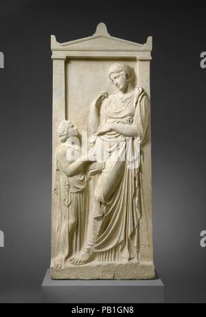 Marble grave stele of a young woman and servant. Culture: Greek, Attic. Dimensions: H. 70 1/16 in. (178 cm). Date: ca. 400-390 B.C..  The young woman leans against the framing pilaster of her grave stele in a pose that may have been inspired by a famous contemporary statue of Aphrodite.  Like the child with doves on the stele found on Paros (acc. no. 27.45, displayed in this gallery), the little girl wears an ungirt peplos that is open at the side. Her hair is cut short in mourning. She holds a jewel box and may be a younger sister of the deceased or a household slave. Museum: Metropolitan Mus Stock Photo