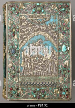 Gospel with Silver Cover. Dimensions: Pages: H. 10 in. (25.4 cm)   W. 6 3/4 in. (17.1 cm)  Binding: H. 10 1/4 in. (26 cm)   W. 7 3/8 in. (18.7 cm)  Approx. opening with cradle: H. 10 1/4 in. (26 cm)   W. 13 3/4 in. (34.9 cm)   D. 8 in. (20.3 cm). Date: 13th and 17th century.  These jeweled, enameled, and gilt-silver repoussé covers for a gospel are examples of the work produced in the late seventeenth-century silversmith workshop of Kayseri. Both front and back cover are signed, informing us that they were made in Kayseri in 1691 by Astuatsatur Shahamir. The central image on the front cover de Stock Photo