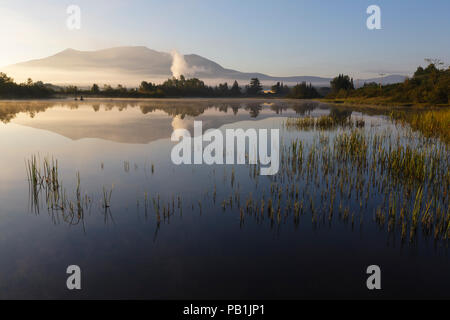 Reflection of Cherry Mountain in Airport Marsh, near Mt Washington Regional Airport, in Whitefield, New Hampshire USA a foggy summer morning. Stock Photo