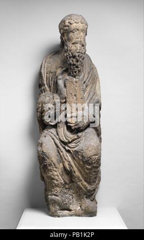 Sculpture of Moses with Tablets of the Law. Culture: French. Dimensions: Overall: 49 x 15 3/4 x 13 3/8 in. (124.5 x 40 x 34 cm). Date: ca. 1170.  This sculpture of Moses, holding the tablets with the Ten Commandments, and the opposite figure, his brother Aaron, form part of a rare ensemble of key figures from the Hebrew Bible. Often shown together on Gothic portals as forerunners of Jesus, they and other statues originally flanked an enthroned Virgin and Child that still survives in the Gothic cathedral at Noyon. The sculptures are distinguished by garments of weighty fabric arranged in swelli Stock Photo