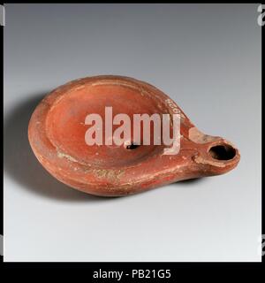 Terracotta oil lamp. Culture: Roman, Cypriot. Dimensions: Overall: 3/4 x 3 1/2 in. (1.9 x 8.9 cm). Museum: Metropolitan Museum of Art, New York, USA. Stock Photo