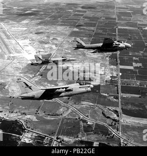 A-7E F-18A and A-6E over NAS Fallon 1987. An air-to-air right side view of, from front to back, an A-7E Corsair II aircraft, an F/A-18A Hornet aircraft and an A-6E Intruder aircraft from Naval Strike Warfare Center, Naval Air Station, Fallon, Nev. Stock Photo