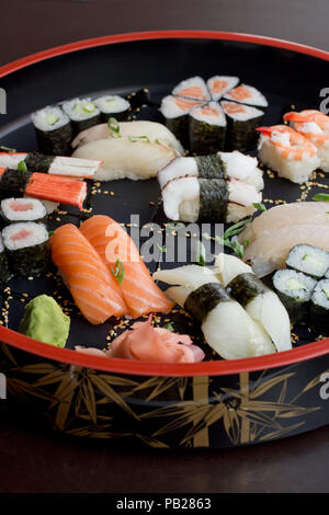 selection of Sushi on a bamboo round tray, vertical Stock Photo