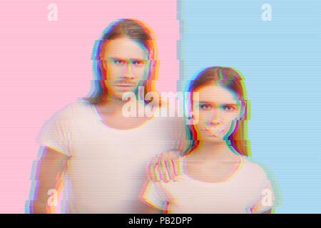 Young woman suffering from domestic violence and her husband looking angry Stock Photo