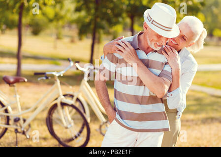 Loving elderly husband and wife embracing and smiling Stock Photo