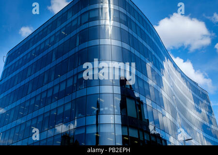 Old buildings reflected in a new glass fronted building in Queen Street, Glasgow, Scotland Stock Photo