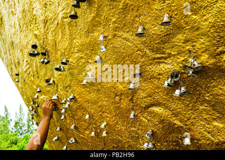 gold and silver bell hang on titan gold stone, concept about spiritual, bell meaning you can hear sound from far away Stock Photo