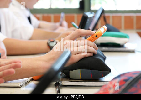 High school students working on using an ipad tablet style electronic computer device. modern pedagogy and teaching learning in education educational Stock Photo