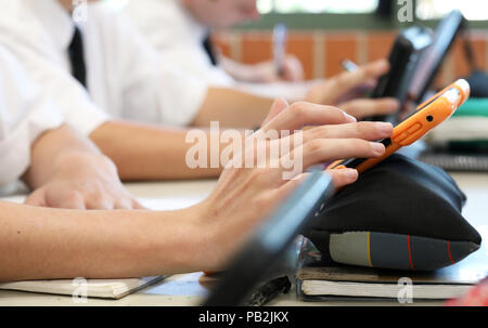 High school students working on using an ipad tablet style electronic computer device. modern pedagogy and teaching learning in education educational Stock Photo