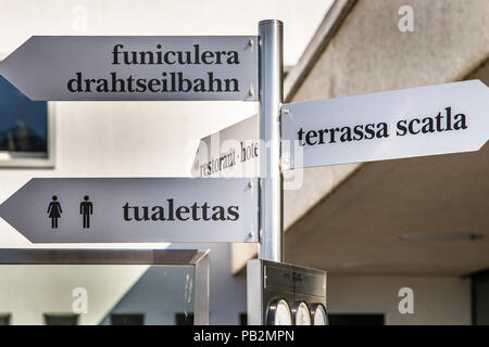 In Switzerland, Romansh, which is spoken by only a few people, is also an important language. Direction Signs in Rhaeto-Romanic Language on Top of Muottas Muragl, Switzerland Stock Photo