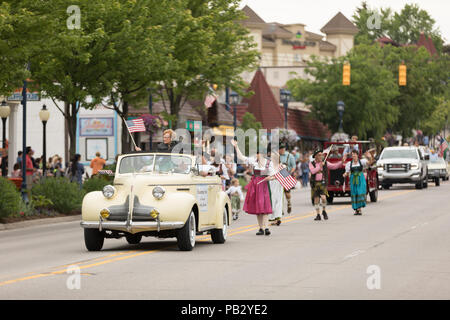 Frankenmuth, Michigan, USA - June 10, 2018 Co founder of the Bavarian Inn ridding on a classic car going down the road at the Bavarian Festival Parade Stock Photo