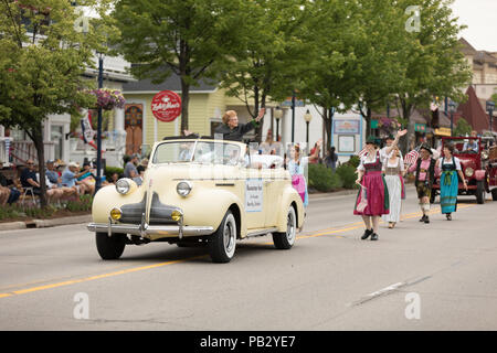 Frankenmuth, Michigan, USA - June 10, 2018 Co founder of the Bavarian Inn ridding on a classic car going down the road at the Bavarian Festival Parade Stock Photo