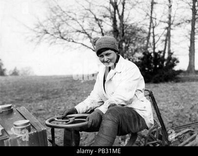 Official photograph showing female farmer driving a tractor Stock Photo ...
