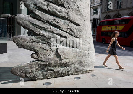 Londoners walk past the sculpture entitled City Wing on Threadneedle Street in the City of London, the capital's financial district, on 25th July 2018, in London, England. City Wing is by the artist Christopher Le Brun. The ten-metre-tall bronze sculpture is by President of the Royal Academy of Arts, Christopher Le Brun, commissioned by Hammerson in 2009. It is called ‘The City Wing’ and has been cast by Morris Singer Art Founders, reputedly the oldest fine art foundry in the world. Stock Photo