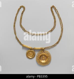 Gold necklace with coin pendants. Culture: Roman. Dimensions: Other: 31 1/2 in. (80 cm)  Diam. (Large coin): 2 3/16 in. (5.6 cm)  Diam. (Small coin): 1 3/8 in. (3.5 cm). Date: 3rd century A.D..  Two openwork pendants are suspended from a double chain of figure-of-eight loops. Each pendant is set with an aureus (gold coin) of the Emperor Alexander Severus (r. A.D. 222-235). Their different sizes and the second spacer suggest that additional pendants are now missing from the chain. The use of coins in jewelry became very fashionable in the third century and persisted until the early seventh cent Stock Photo
