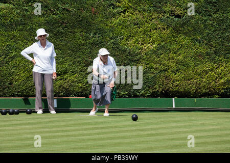 Windsor, UK. 26th July, 2018. Two women enjoy a game of bowls on a still pristine lawn at the Windsor and Eton Bowling Club on a very hot summer's day. Temperatures are expected to reach 36C today in the south-east. Even if imposed, sports facilities such as bowling clubs are often exempt from water restrictions during a drought. Credit: Mark Kerrison/Alamy Live News Stock Photo